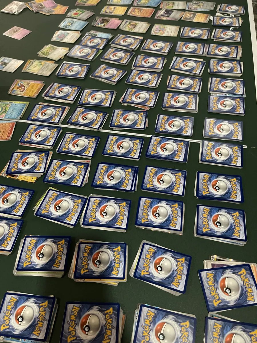 Pokémon cards arranged in small stacks across a table.
