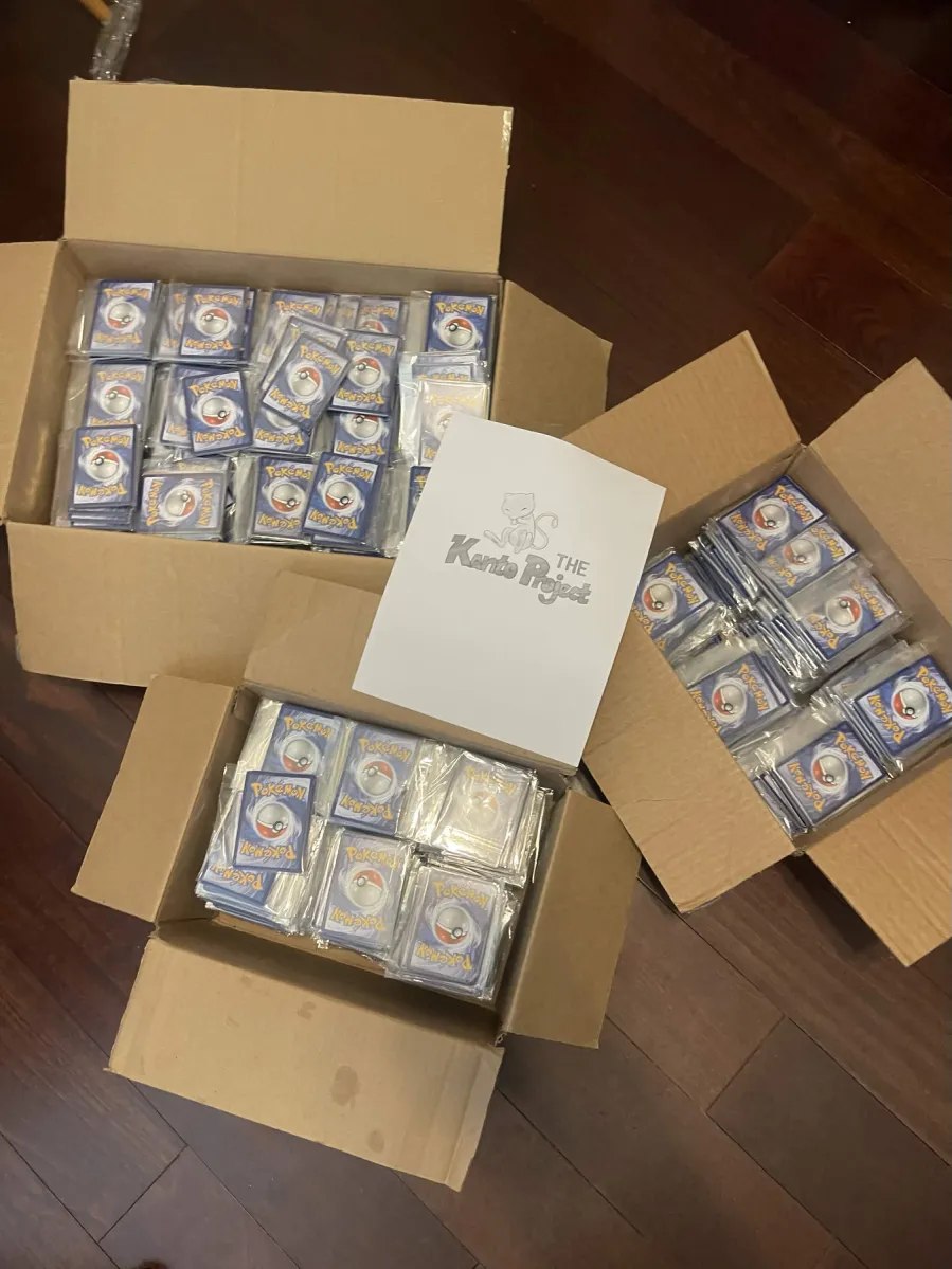 Three boxes of individually packed cards surrounding The Kanto Project logo.